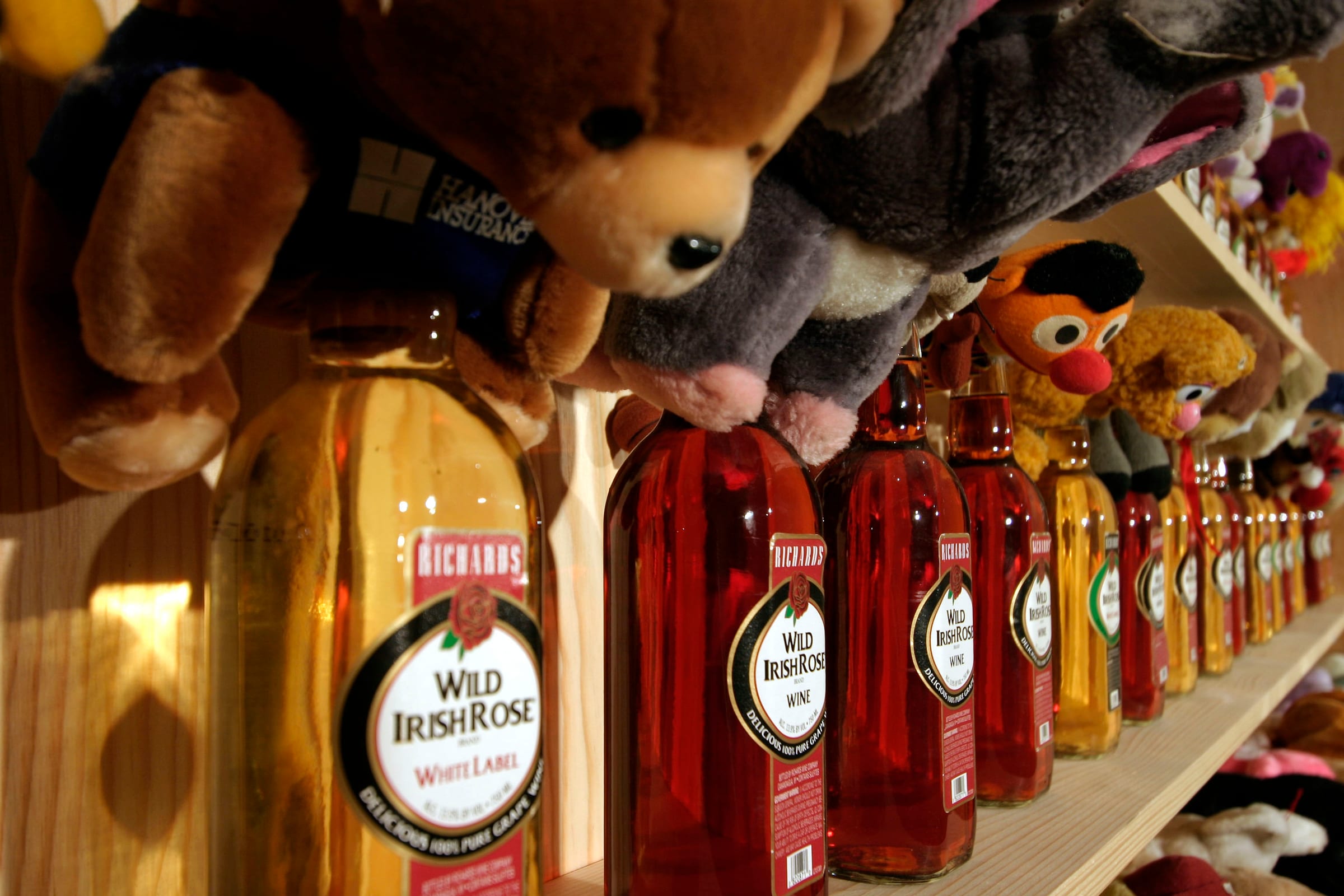 Party Room, 1998, installation with 119 Wild Rose Bottles, 119 stuffed animals, 8 shelves (detail)